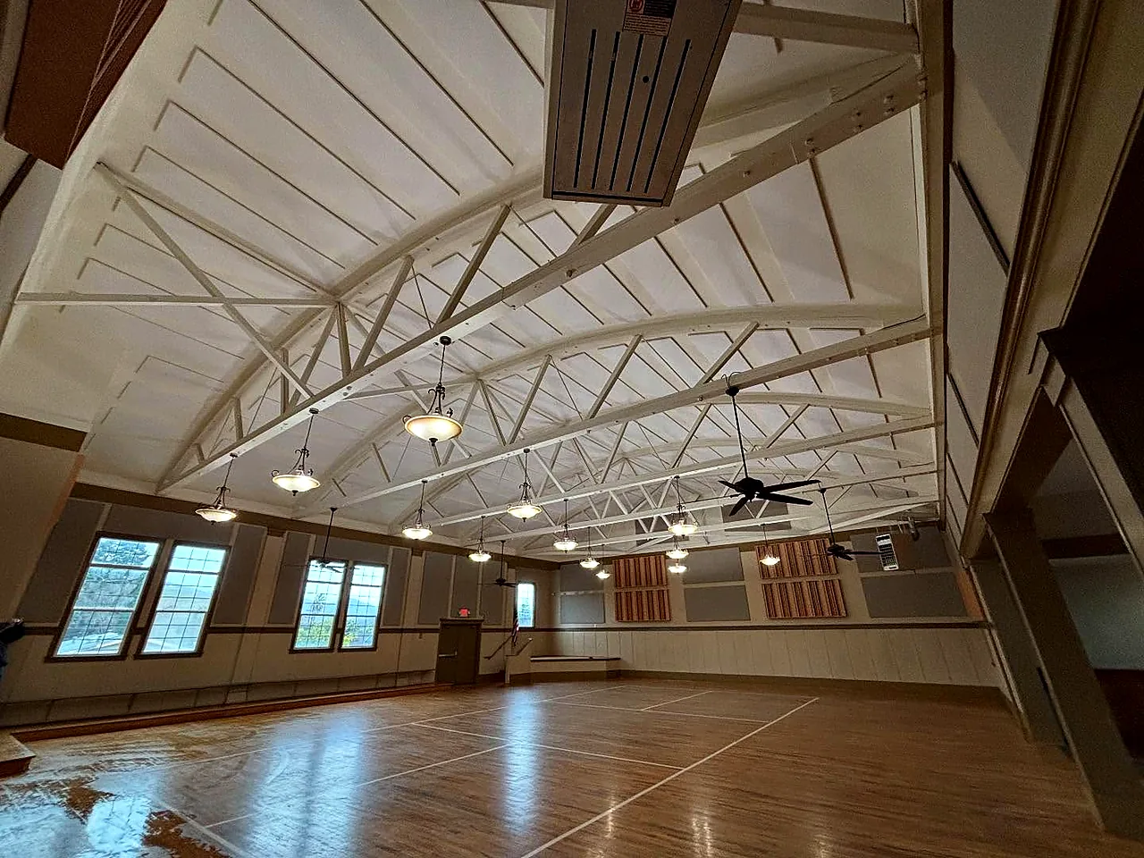 Exposed wood truss ceiling in assembly hall